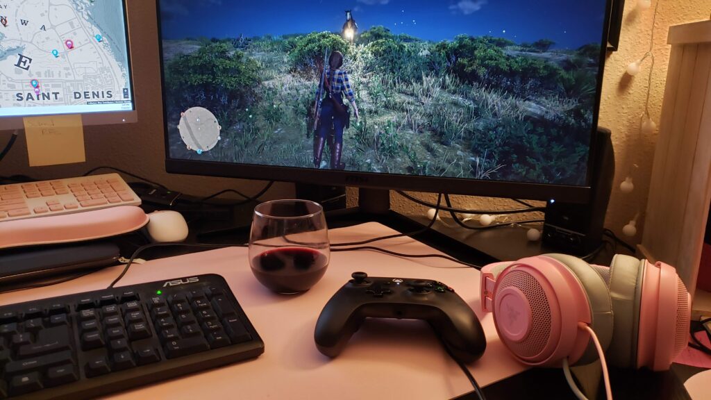 Glass of wine, game controller, game headset and pc