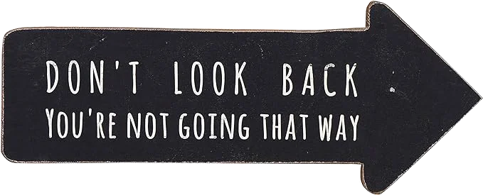 Plaque saying "Don't Look Back, You're not going that way"
